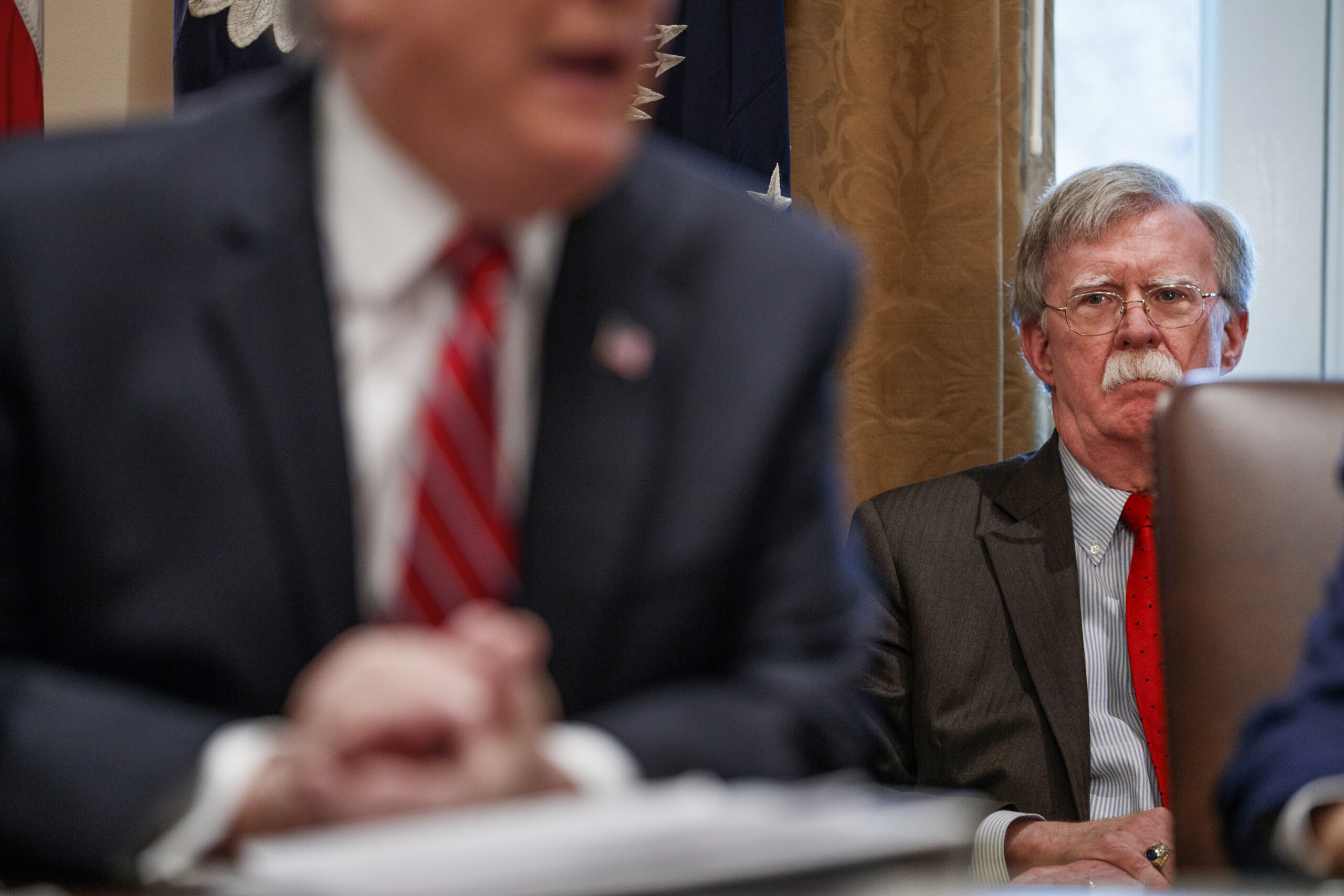 National security adviser John Bolton listens as President Donald Trump speaks during a cabinet meeting at the White House, Tuesday, Feb. 12, 2019, in Washington. (AP Photo/ Evan Vucci)