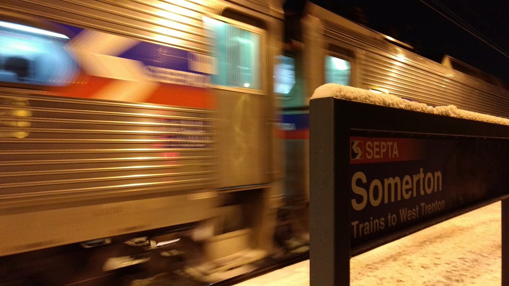 Photo of SEPTA train and station sign at night
