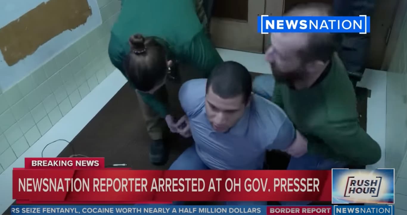 A screen capture of a NewsNation broadcast shows law enforcement arresting journalist Evan Lambert on Feb. 8, 2023.