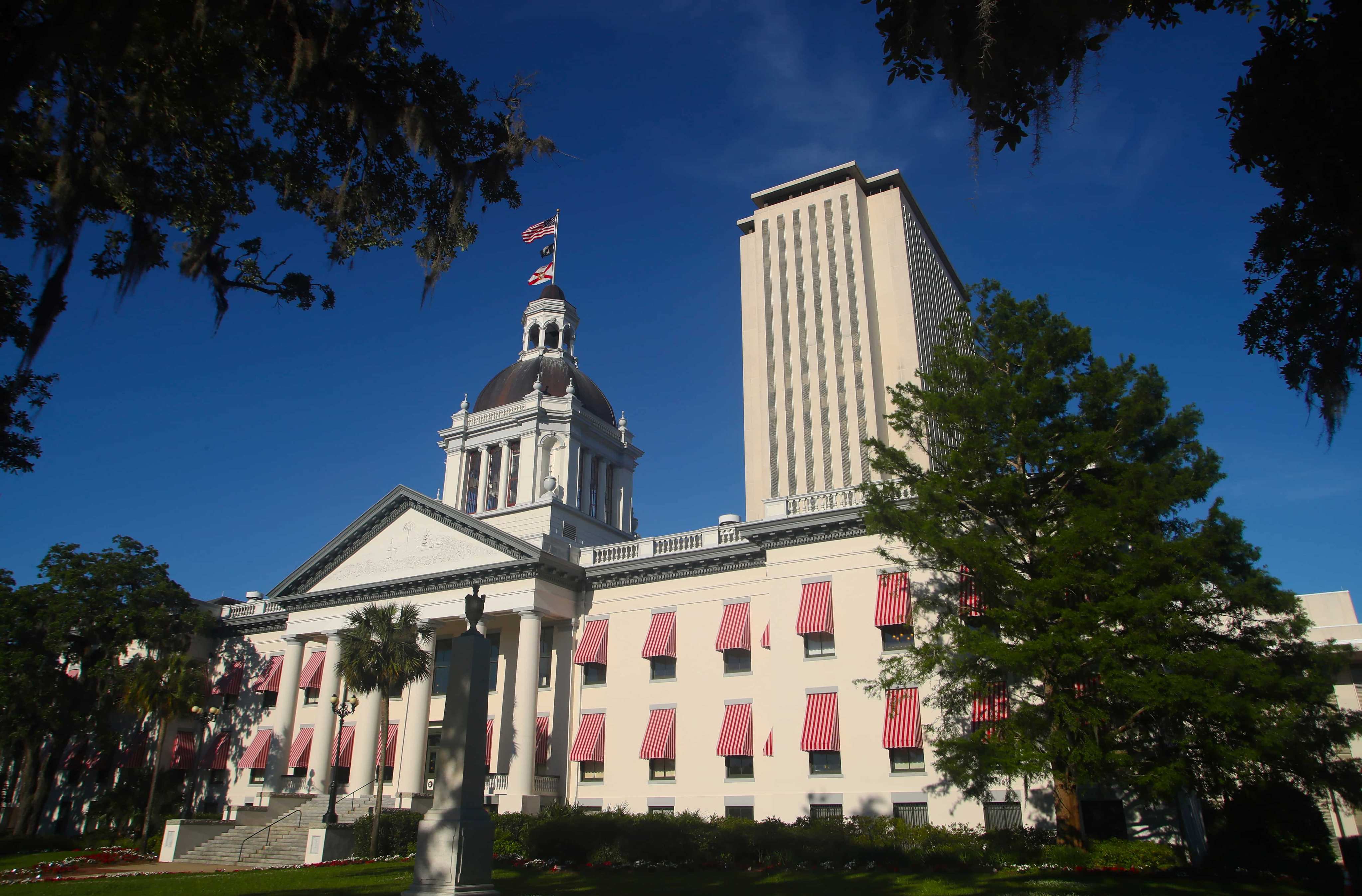 An American flag flies over the Florida Capitol, Tuesday April 23, 2019 in Tallahassee, Fla. The Florida Legislature is in its final two weeks of session. (AP Photo/Phil Sears)