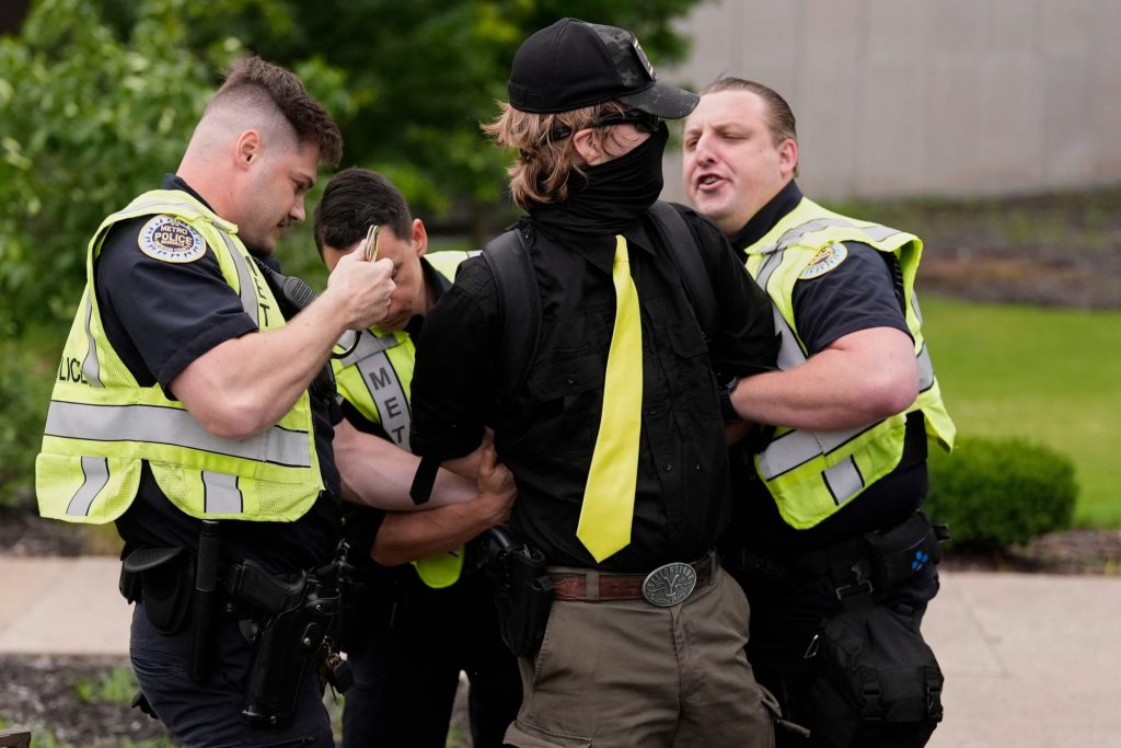A man is arrested by Metro Nashville Police Department officers as he was carrying a handgun and allegedly harassing demonstrators during a "No Kings" protest Saturday, June 14, 2025, in Nashville, Tenn. (AP Photo/George Walker IV)