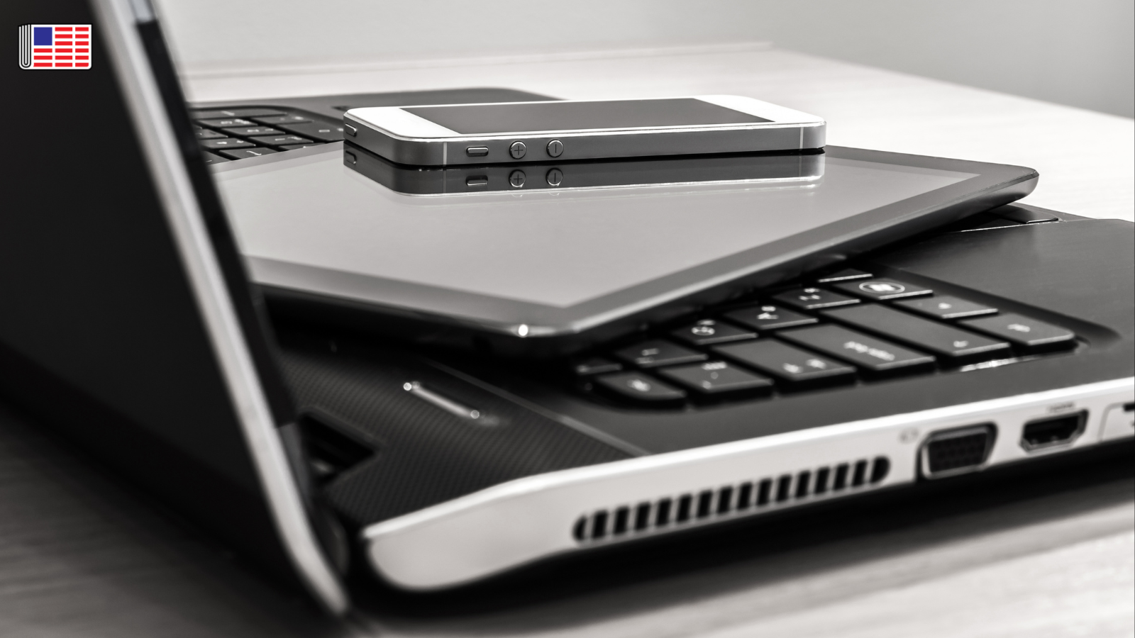 A laptop, tablet and cell phone are shown stacked on one another. On the top left corner, the Reporters Committee flag logo is shown.