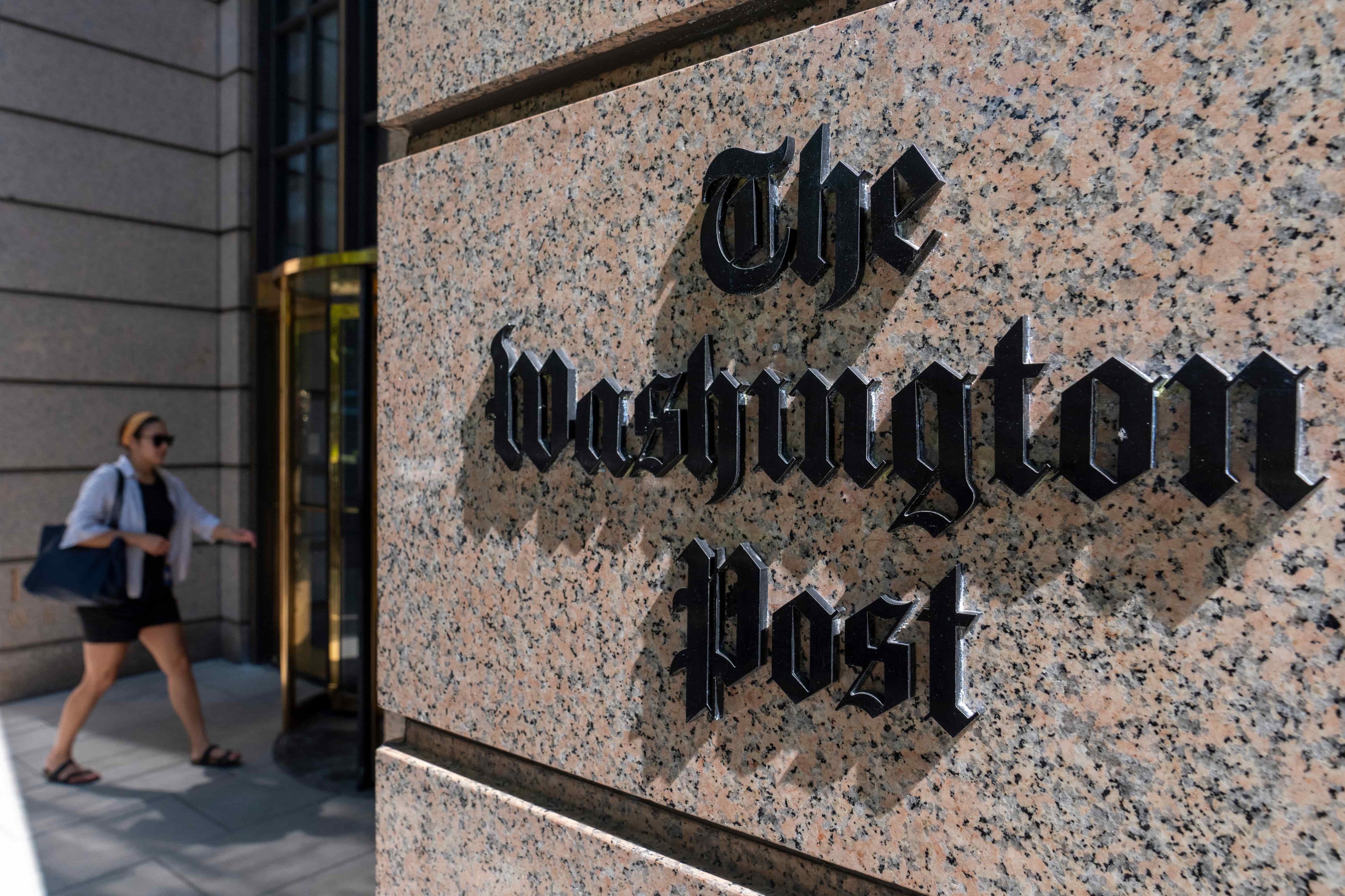 A person walks into the One Franklin Square Building, home of The Washington Post newspaper, June 21, 2024, in Washington. (AP Photo/Alex Brandon)
