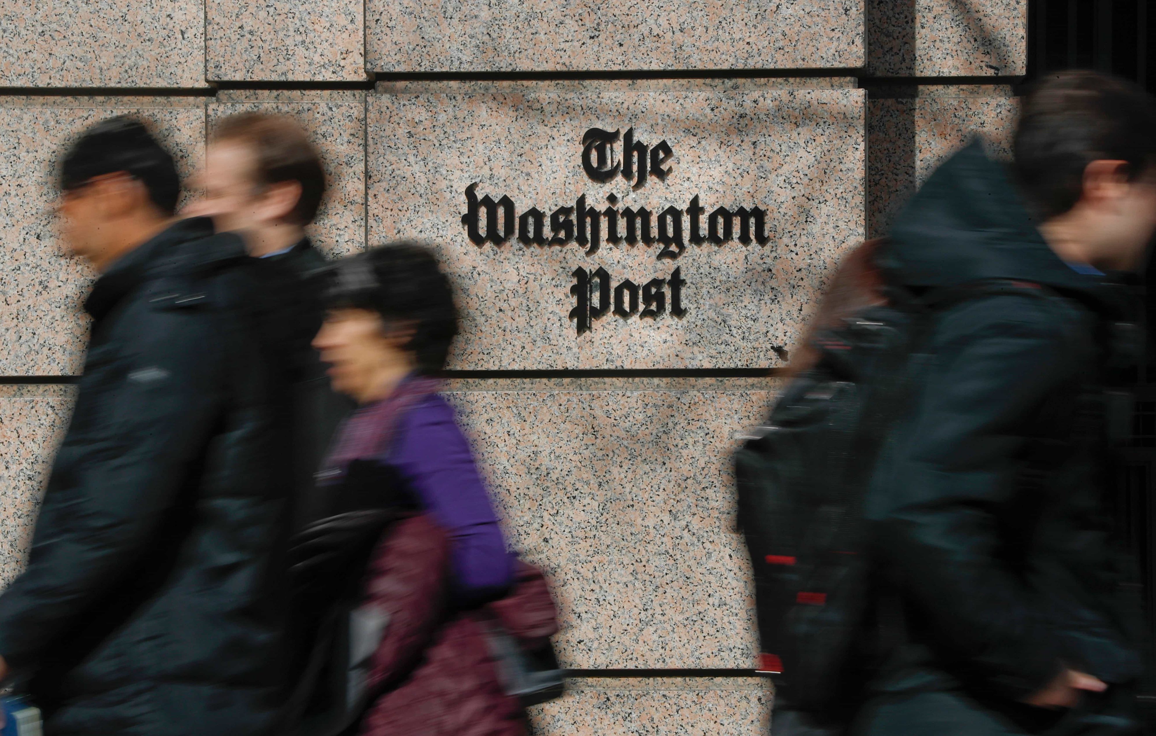 People walk by the One Franklin Square Building, home of The Washington Post newspaper, in downtown Washington on Feb. 21, 2019. (AP Photo/Pablo Martinez Monsivais)