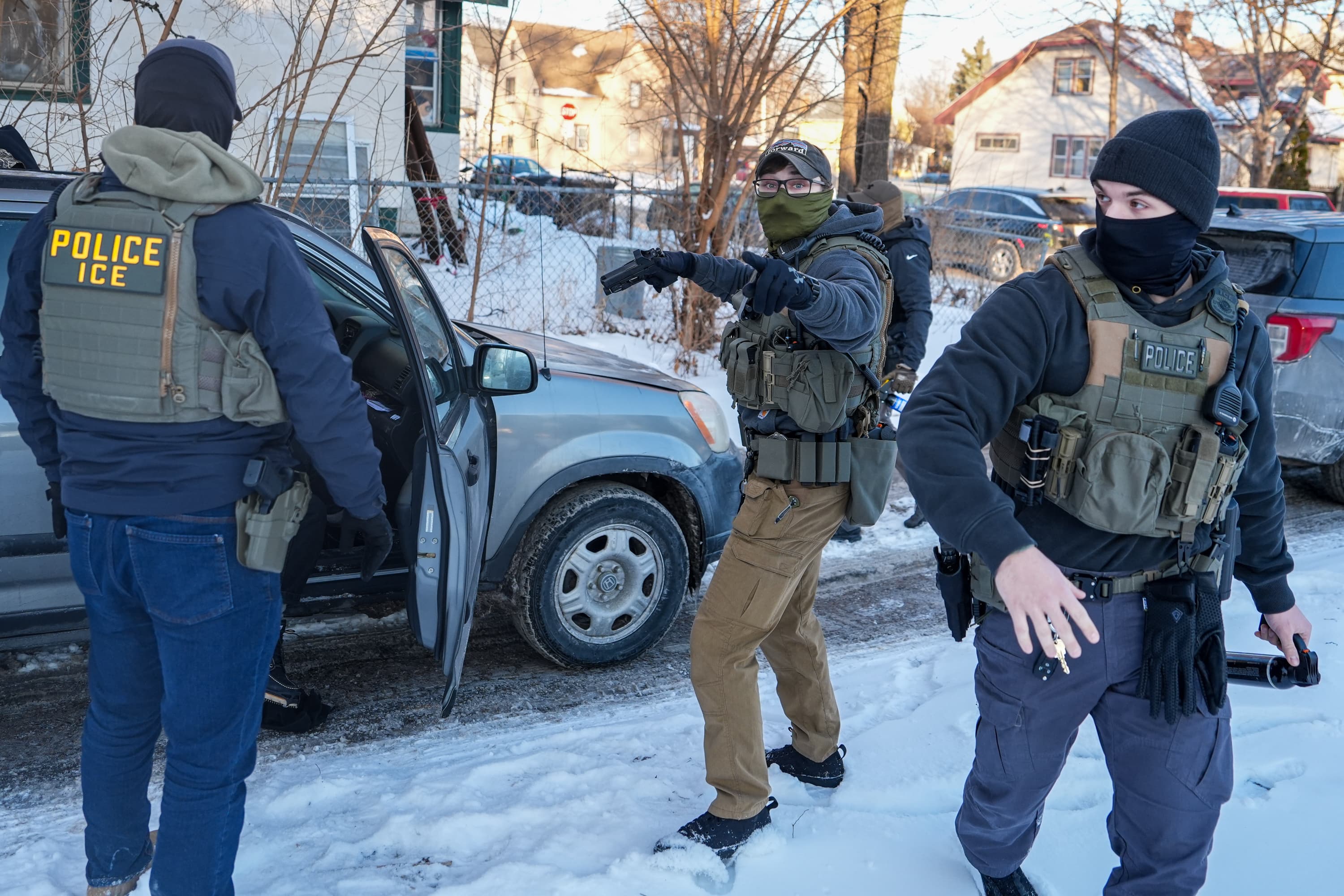 A federal agent warns members of the media to back up, while confronting an activist during immigration enforcement operations on Tuesday, Feb. 3, 2026, in Minneapolis. (AP Photo/Ryan Murphy)