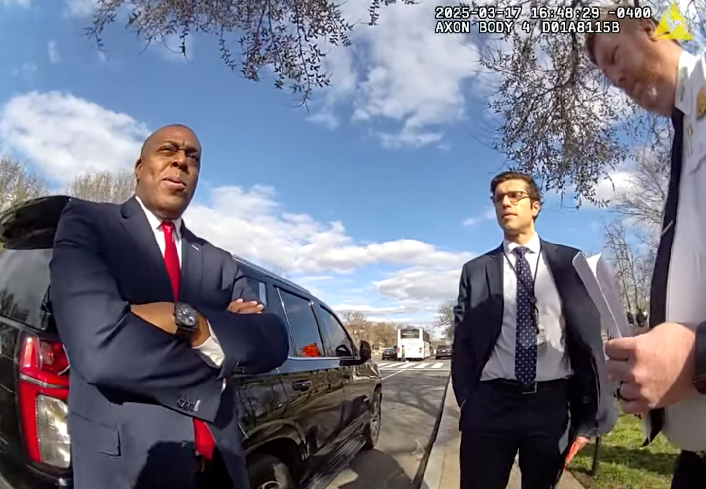 A screen capture from bodycam footage shows two Trump administration officials speaking with a D.C. police officer about their plans to take control of the U.S. Institute of Peace.