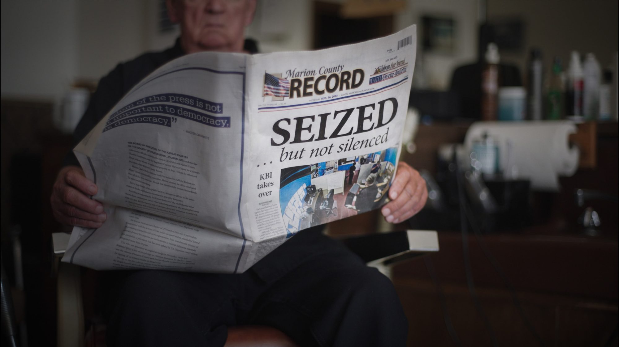 Person holding a copy of the Marion County Record