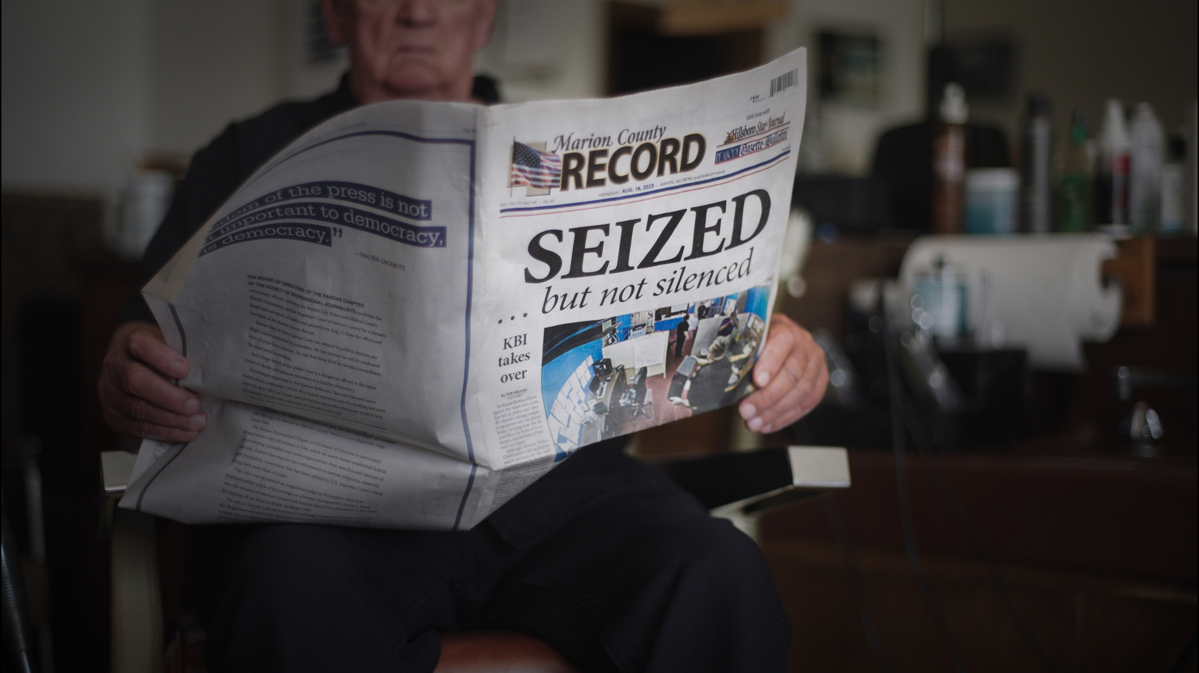 Person holding a copy of the Marion County Record