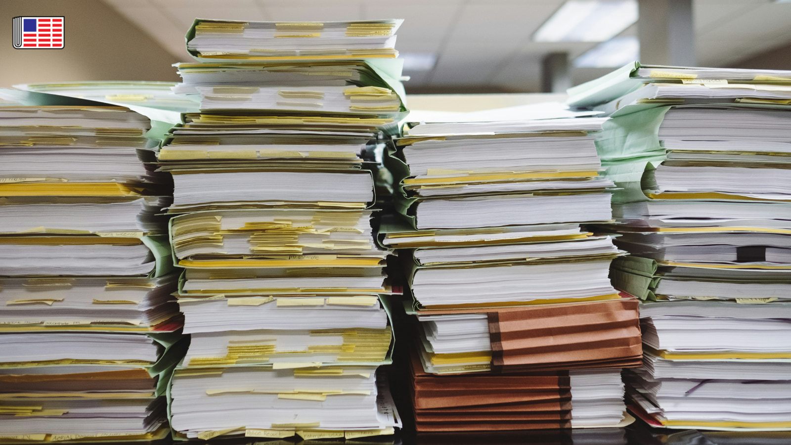 Stacks of documents piled on a table