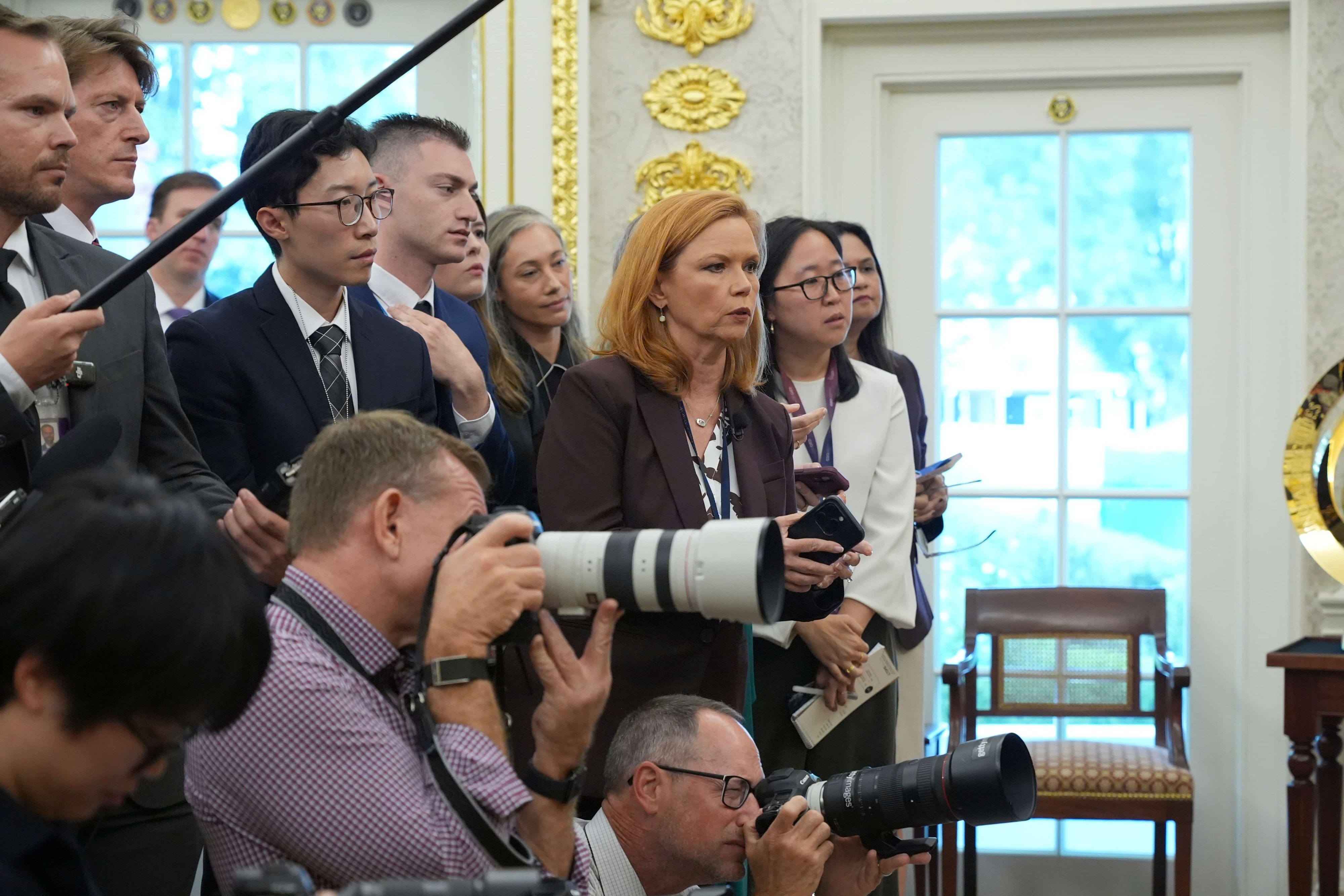 Journalists listen as President Donald Trump speaks during an event about healthcare in the Oval Office of the White House, Friday Sept. 18, 2026, in Washington. (AP Photo/Jacquelyn Martin)
