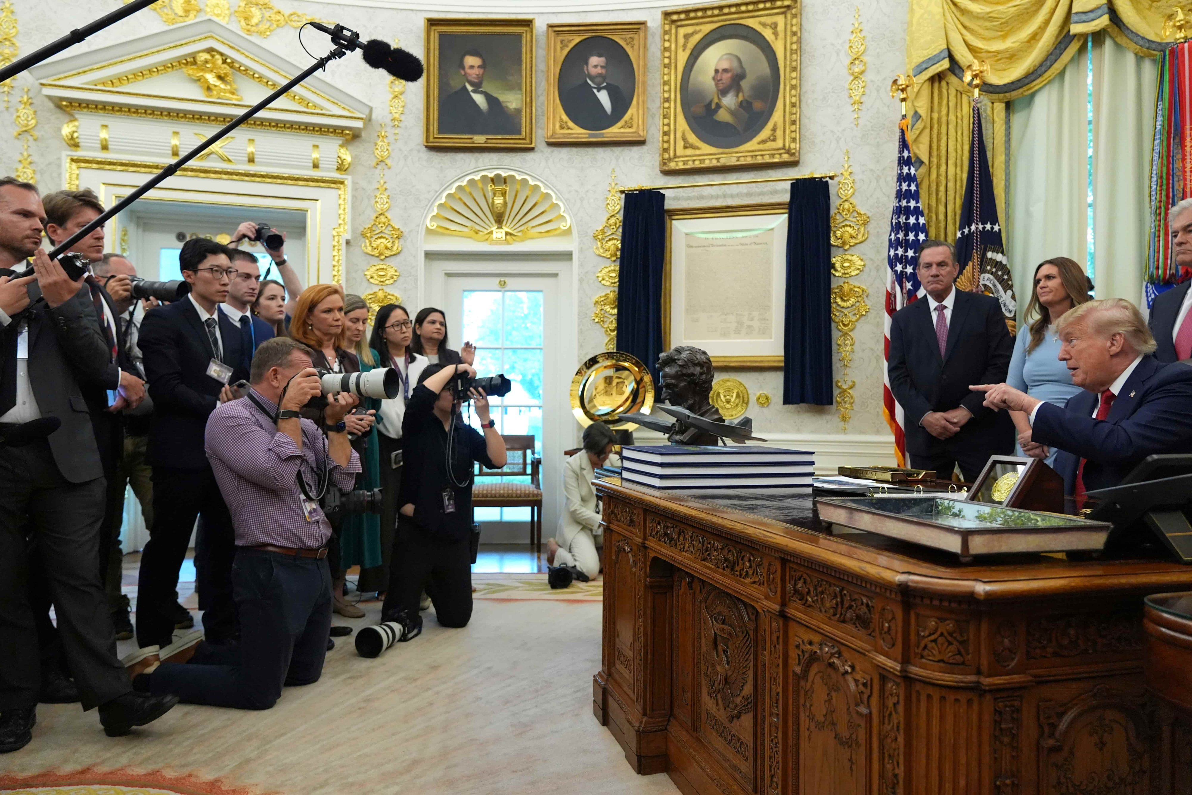 President Donald Trump, seated right, points to reporters as he speaks during an event about healthcare in the Oval Office of the White House, Friday Sept. 18, 2026, in Washington. (AP Photo/Jacquelyn Martin)