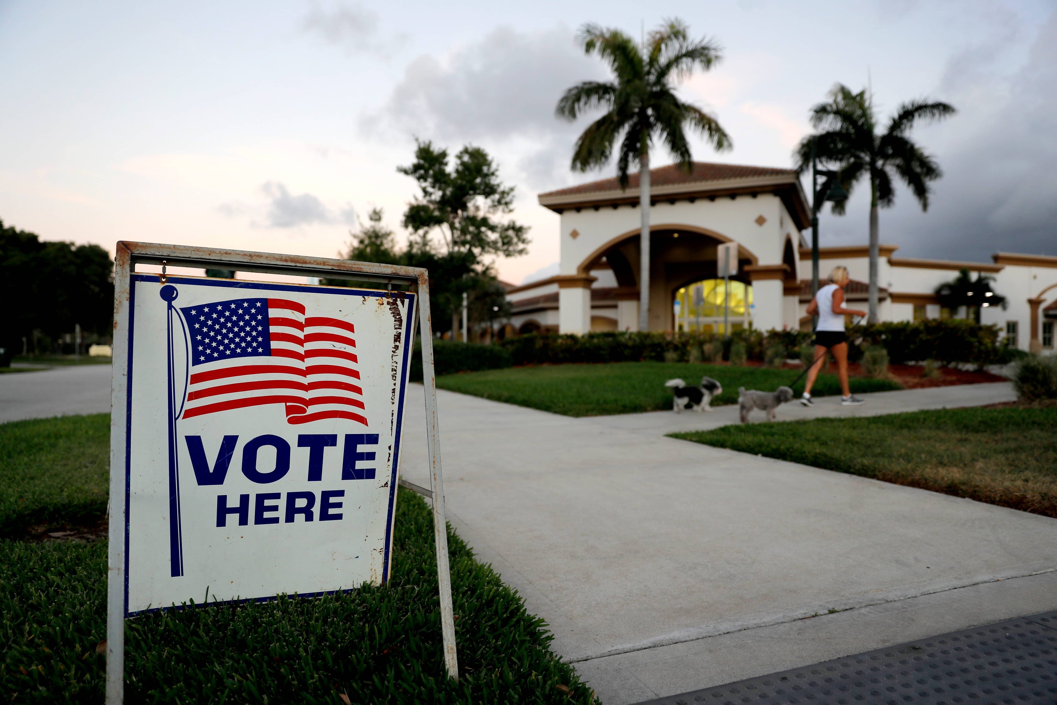 A sign is placed outside of a polling place at the Boca Raton Library during the Florida primary election, Tuesday, March 17, 2020, in Boca Raton, Fla. (AP Photo/Julio Cortez)